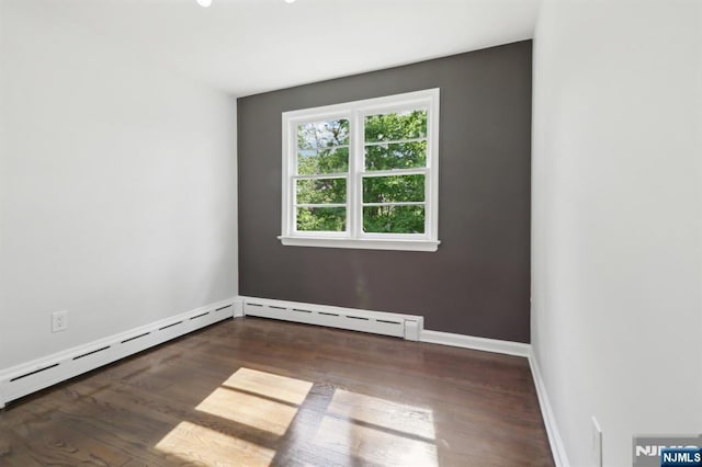 8 Oak St, Netcong Borough, NJ 07857 - empty room with wood finished floors, baseboards, and a baseboard heating unit