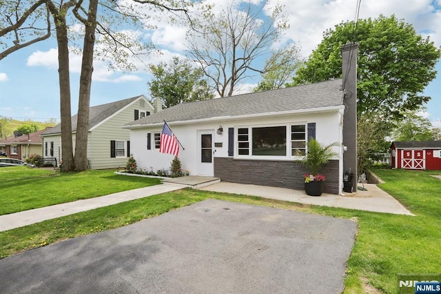 8 Oak St, Netcong Borough, NJ 07857 - view of front of house with a front yard, a chimney, stucco siding, and stone siding