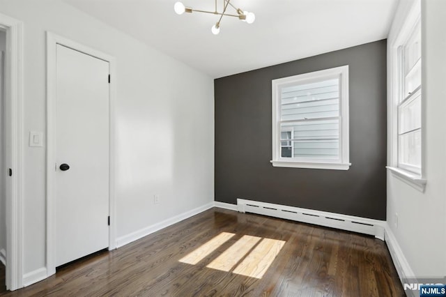 8 Oak St, Netcong Borough, NJ 07857 - unfurnished room with a baseboard heating unit, a chandelier, wood finished floors, and baseboards