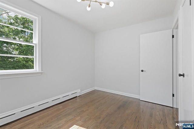 8 Oak St, Netcong Borough, NJ 07857 - spare room featuring baseboard heating, healthy amount of natural light, wood finished floors, and a chandelier