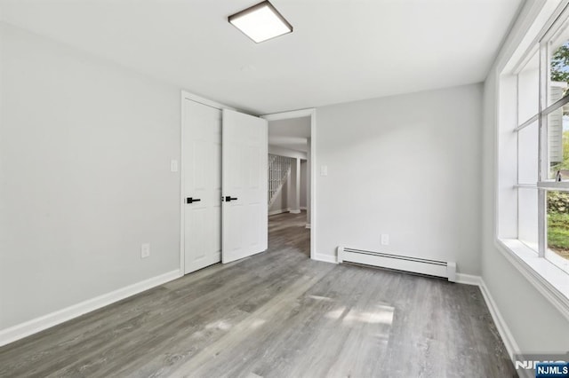 8 Oak St, Netcong Borough, NJ 07857 - unfurnished room with baseboard heating, wood finished floors, and baseboards