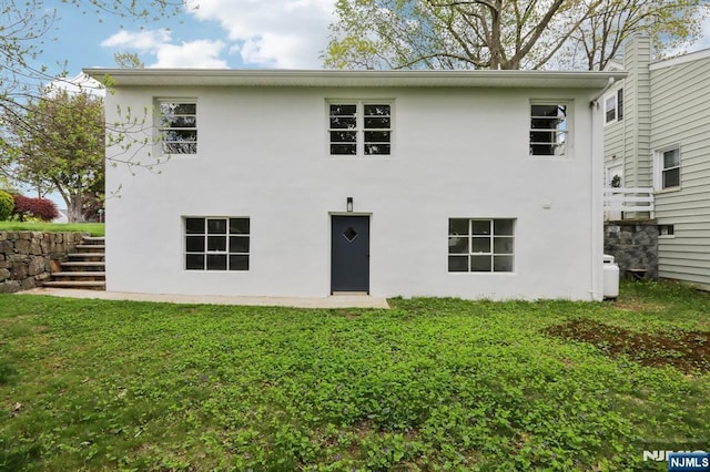 8 Oak St, Netcong Borough, NJ 07857 - back of house featuring stucco siding, stairs, and a yard