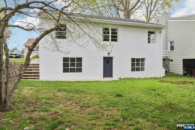 8 Oak St, Netcong Borough, NJ 07857 - back of house with stucco siding and a lawn