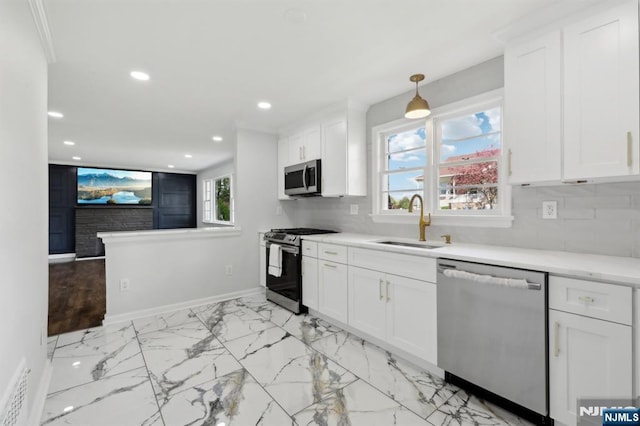 8 Oak St, Netcong Borough, NJ 07857 - kitchen featuring appliances with stainless steel finishes, a sink, baseboards, a fireplace, and light countertops