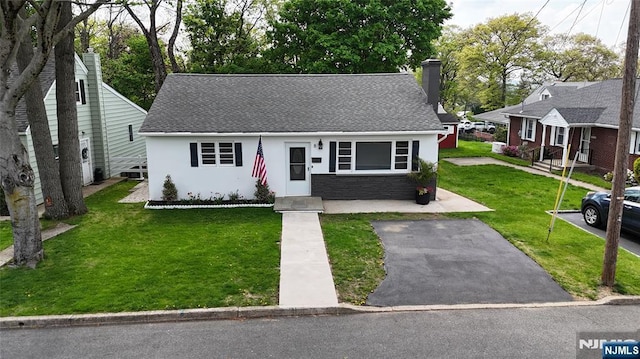 8 Oak St, Netcong Borough, NJ 07857 - view of front of home featuring a chimney, a front yard, stucco siding, and roof with shingles