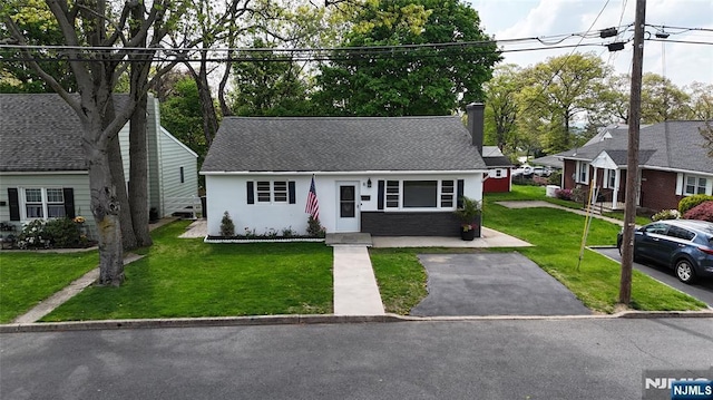 8 Oak St, Netcong Borough, NJ 07857 - view of front of house with a chimney, a front lawn, stucco siding, and roof with shingles
