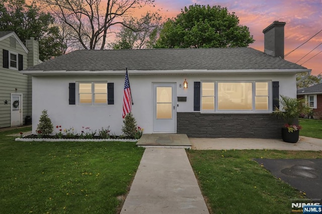 8 Oak St, Netcong Borough, NJ 07857 - view of front facade featuring stucco siding, a front yard, and a chimney