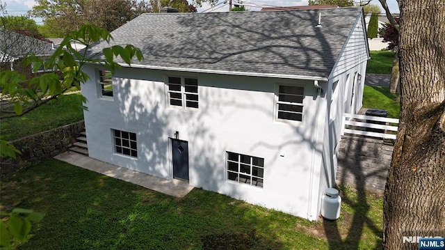 8 Oak St, Netcong Borough, NJ 07857 - back of property featuring roof with shingles, stucco siding, and a yard