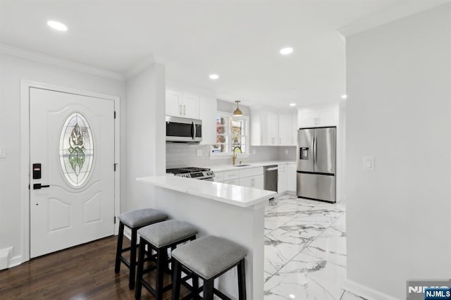 8 Oak St, Netcong Borough, NJ 07857 - kitchen with stainless steel appliances, a sink, a kitchen bar, light countertops, and white cabinets