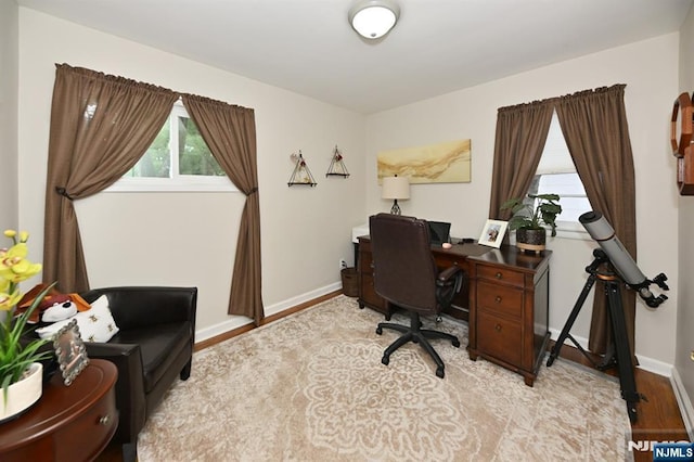 office space featuring light wood finished floors and baseboards
