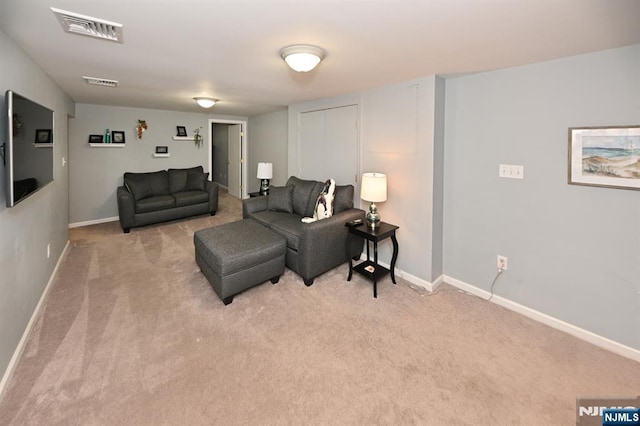 living area with light carpet and baseboards