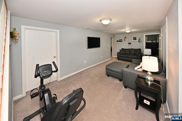 exercise room featuring carpet flooring and baseboards