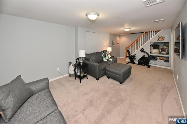 living room featuring stairway, carpet floors, and baseboards