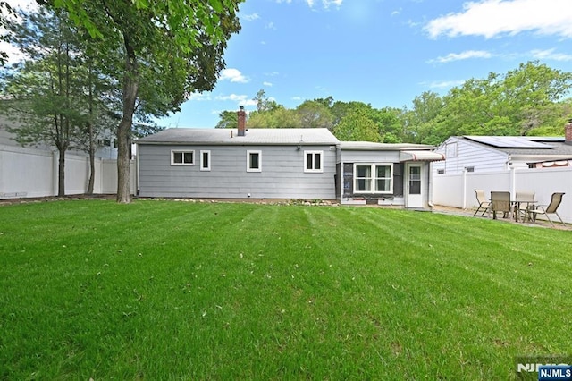 rear view of house featuring a chimney