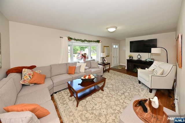 living area featuring wood finished floors and baseboards