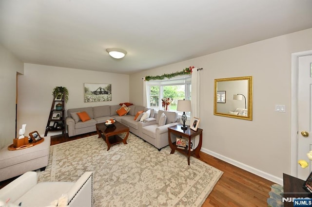 living room featuring wood finished floors and baseboards