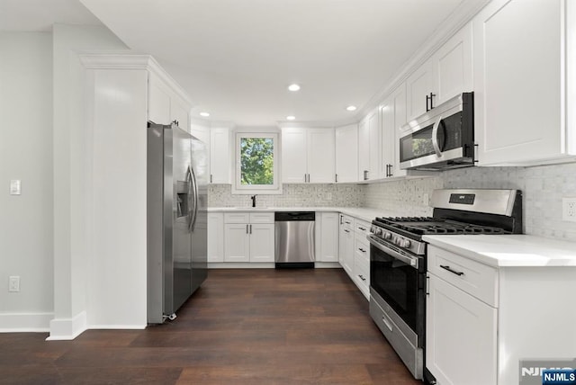 240 Berry St, Hackensack, NJ 07601 - kitchen featuring appliances with stainless steel finishes, decorative backsplash, a sink, white cabinetry, and recessed lighting