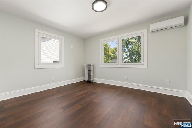 240 Berry St, Hackensack, NJ 07601 - spare room with radiator, a wall mounted AC, baseboards, and dark wood-style floors