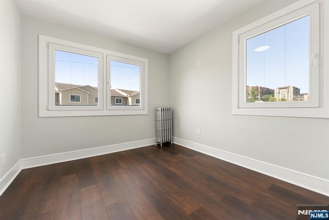 240 Berry St, Hackensack, NJ 07601 - empty room featuring radiator heating unit, baseboards, and dark wood-style floors