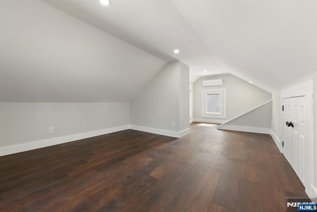 240 Berry St, Hackensack, NJ 07601 - additional living space with a wall mounted air conditioner, lofted ceiling, baseboards, dark wood-type flooring, and recessed lighting