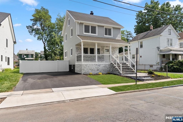 240 Berry St, Hackensack, NJ 07601 - american foursquare style home featuring a porch, stone siding, roof with shingles, and asphalt driveway