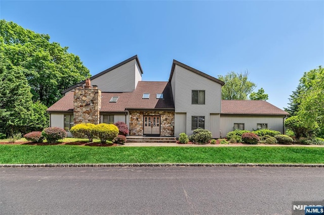 81 Columbus Ave, Totowa, NJ 07512 - view of front facade with stone siding, a front yard, and a shingled roof
