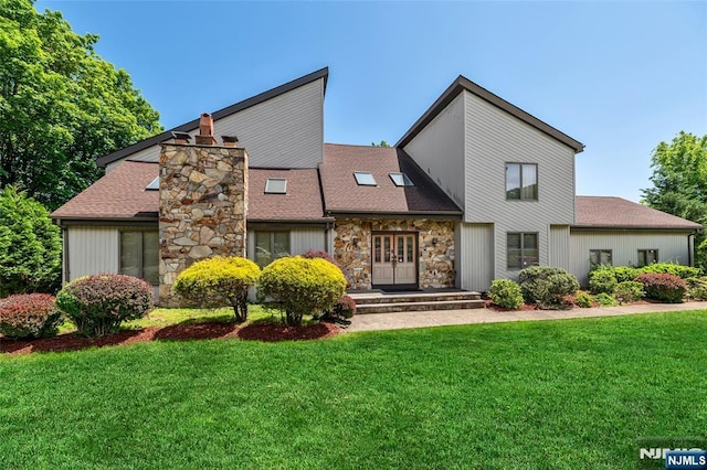 81 Columbus Ave, Totowa, NJ 07512 - view of front of house featuring french doors, stone siding, a front lawn, and roof with shingles
