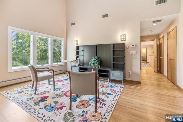 81 Columbus Ave, Totowa, NJ 07512 - home office with light wood-type flooring, a towering ceiling, and baseboards