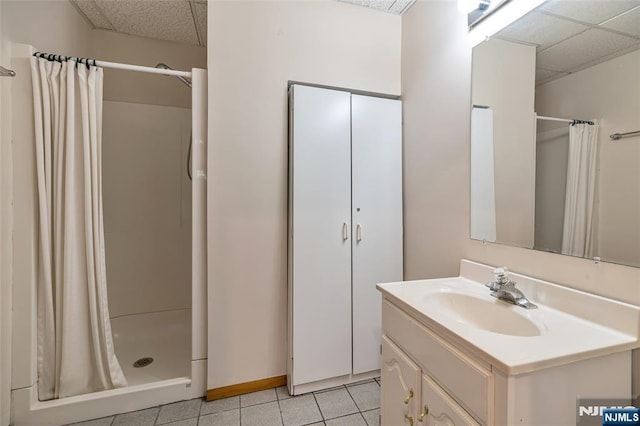 81 Columbus Ave, Totowa, NJ 07512 - full bathroom featuring a paneled ceiling, vanity, tile patterned floors, and curtained shower