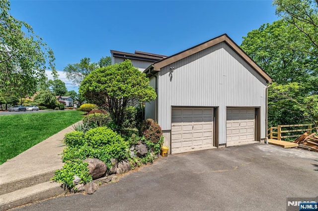 81 Columbus Ave, Totowa, NJ 07512 - view of side of home featuring a garage, an outdoor structure, and a lawn