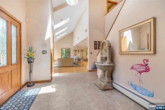 81 Columbus Ave, Totowa, NJ 07512 - tiled entrance foyer with a baseboard heating unit, high vaulted ceiling, and baseboards