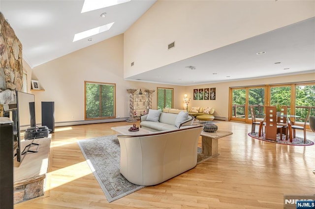 81 Columbus Ave, Totowa, NJ 07512 - living room with high vaulted ceiling, a skylight, light wood-type flooring, baseboard heating, and baseboards