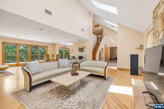 81 Columbus Ave, Totowa, NJ 07512 - living area featuring a skylight, healthy amount of natural light, light wood-style flooring, and high vaulted ceiling