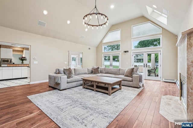 31 Bourbon St, Wayne, NJ 07470 - living area featuring high vaulted ceiling, wood finished floors, french doors, a skylight, and recessed lighting