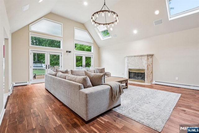 31 Bourbon St, Wayne, NJ 07470 - living area featuring a baseboard heating unit, a skylight, high vaulted ceiling, a high end fireplace, and wood finished floors