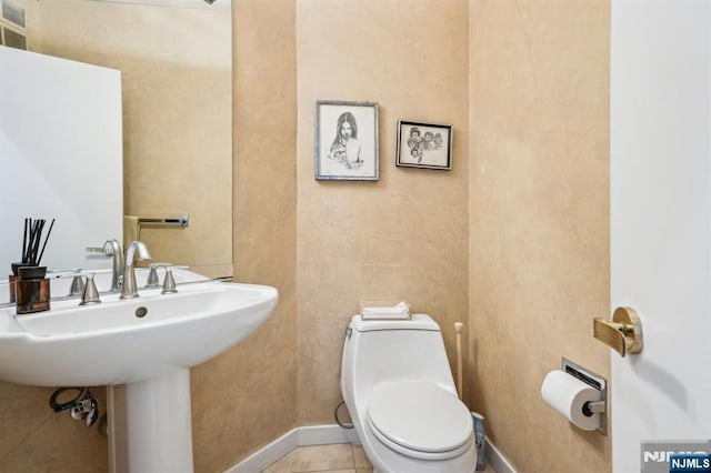 31 Bourbon St, Wayne, NJ 07470 - half bathroom featuring baseboards, toilet, tile patterned flooring, and a sink