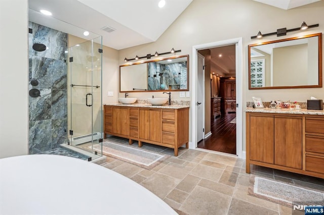31 Bourbon St, Wayne, NJ 07470 - bathroom featuring a stall shower, double vanity, lofted ceiling, a freestanding tub, and baseboard heating