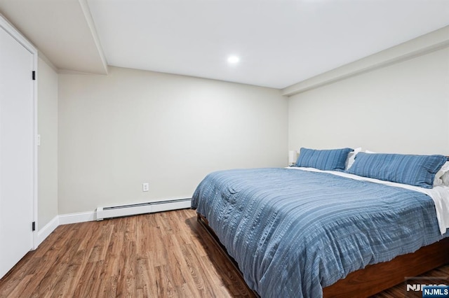31 Bourbon St, Wayne, NJ 07470 - bedroom with baseboard heating, wood finished floors, baseboards, and recessed lighting