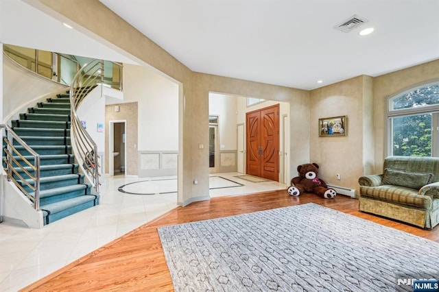 31 Bourbon St, Wayne, NJ 07470 - entryway with a baseboard heating unit, stairway, wood finished floors, and recessed lighting