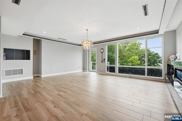 26 Hudson Ter, Edgewater, NJ 07020 - unfurnished living room with a chandelier, light wood-style flooring, baseboards, recessed lighting, and a high end fireplace
