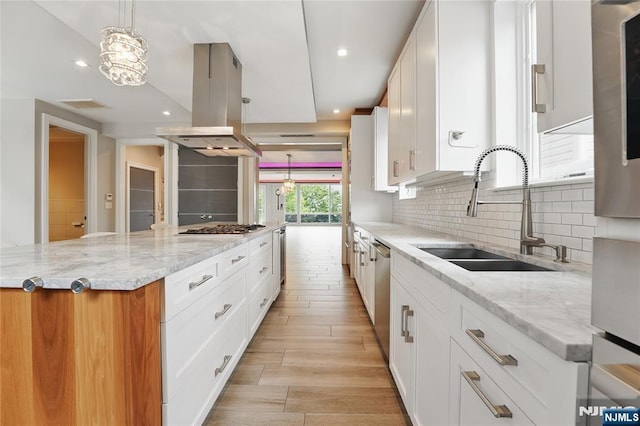 26 Hudson Ter, Edgewater, NJ 07020 - kitchen featuring a sink, island exhaust hood, a spacious island, tasteful backsplash, and appliances with stainless steel finishes