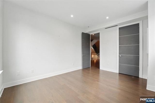 26 Hudson Ter, Edgewater, NJ 07020 - unfurnished bedroom featuring wood finished floors, baseboards, and recessed lighting
