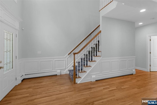 27 Tecumseh Trl, Oakland, NJ 07436 - foyer featuring stairway, a decorative wall, a baseboard radiator, wainscoting, and recessed lighting