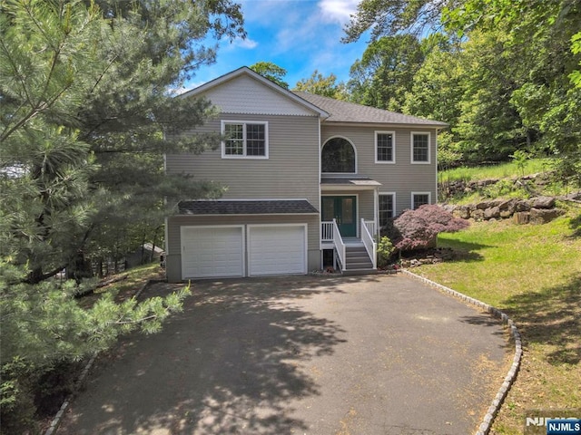 27 Tecumseh Trl, Oakland, NJ 07436 - view of front of home with asphalt driveway and an attached garage