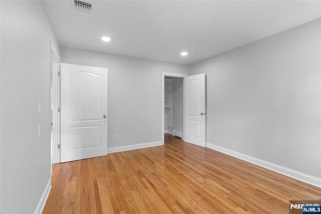 27 Tecumseh Trl, Oakland, NJ 07436 - unfurnished bedroom with light wood-type flooring, baseboards, recessed lighting, a walk in closet, and a closet