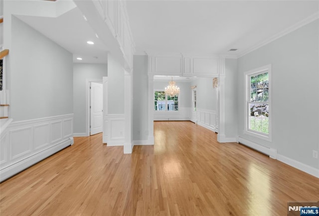 27 Tecumseh Trl, Oakland, NJ 07436 - spare room featuring a chandelier, a baseboard heating unit, plenty of natural light, light wood-style floors, and ornamental molding