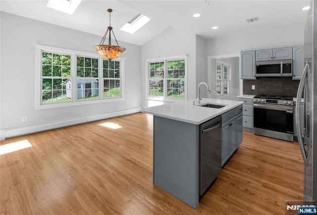 27 Tecumseh Trl, Oakland, NJ 07436 - kitchen with stainless steel appliances, a sink, gray cabinetry, a skylight, and lofted ceiling