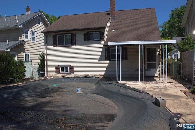 276 Galvan Pl, Bergenfield, NJ 07621 - rear view of house with a patio and a sunroom