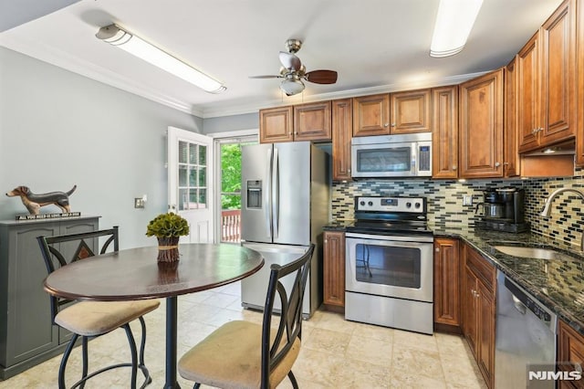104 Leland Trl, Hopatcong, NJ 07843 - kitchen featuring appliances with stainless steel finishes, a sink, backsplash, ceiling fan, and brown cabinets