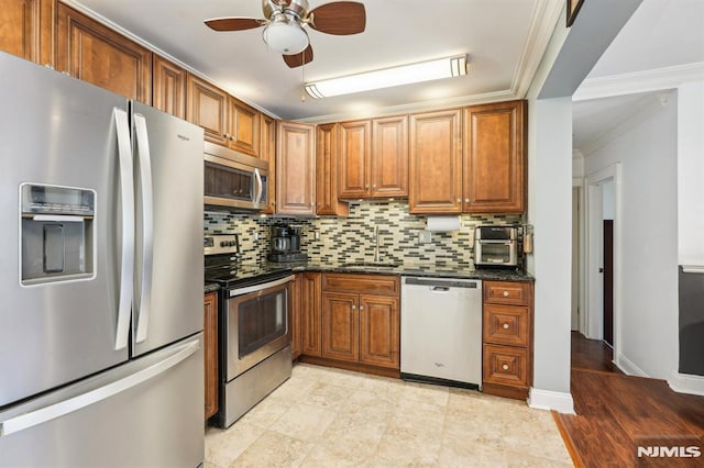 104 Leland Trl, Hopatcong, NJ 07843 - kitchen with stainless steel appliances, tasteful backsplash, ceiling fan, brown cabinets, and ornamental molding